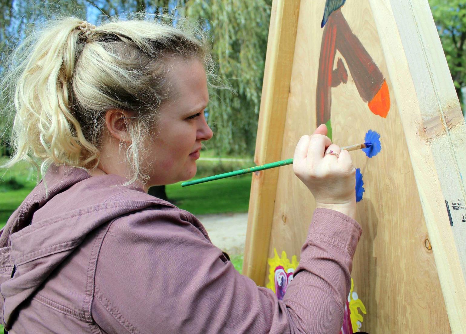 Kori paints on mural